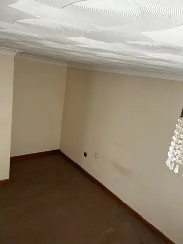 Check-out photo: empty lounge with marked carpet