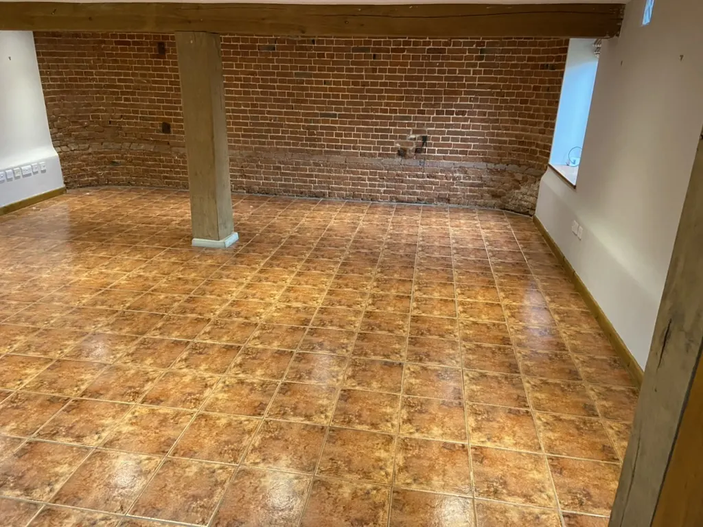 Before: the same barn room with old orange terracotta tiles